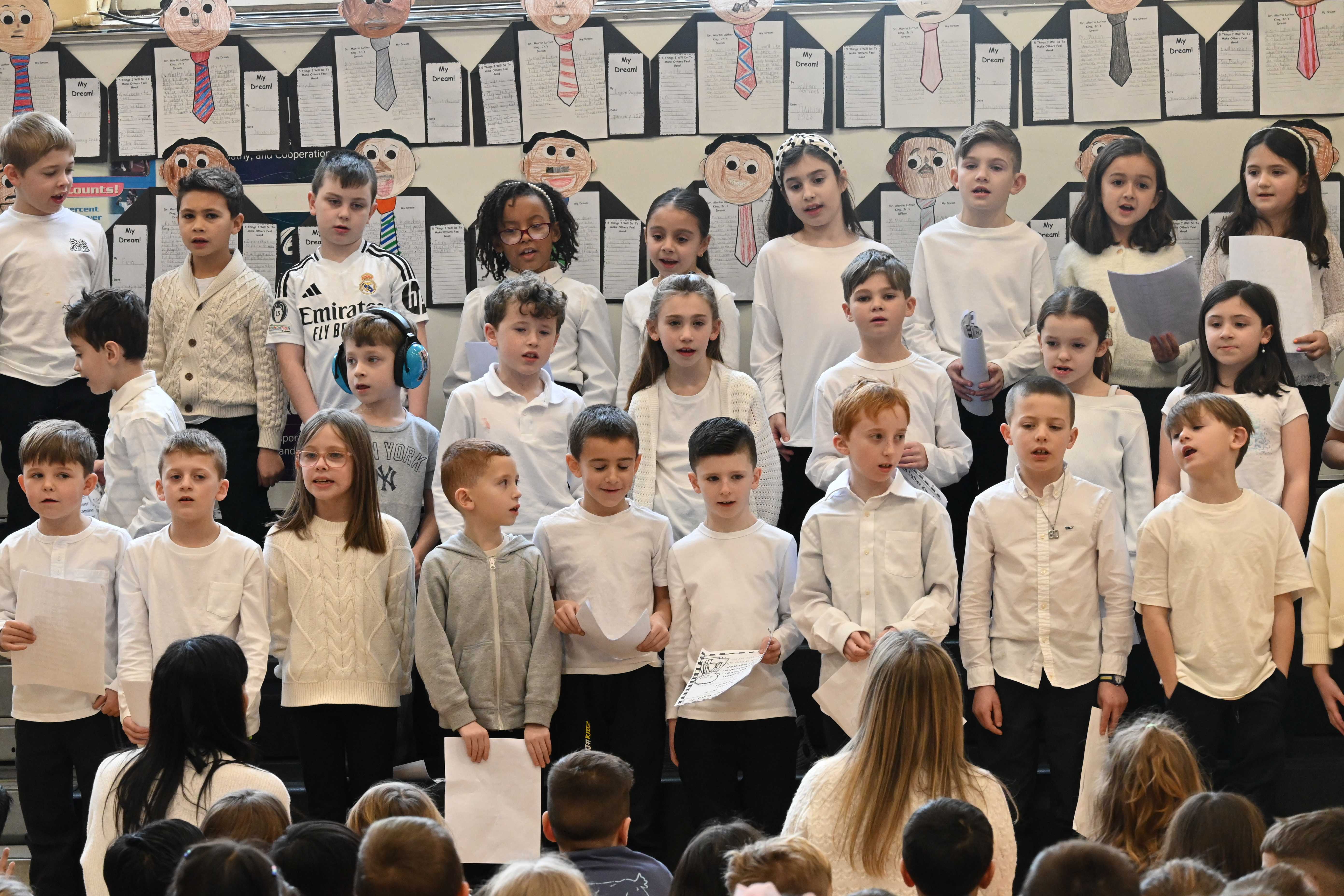 kids in white tops singing